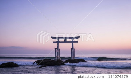 A mystical view of a torii gate standing on the seashore and the morning glow 134074279