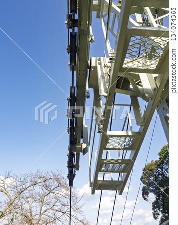 The rugged beauty of the lift's structure stands out against the blue sky 134074365