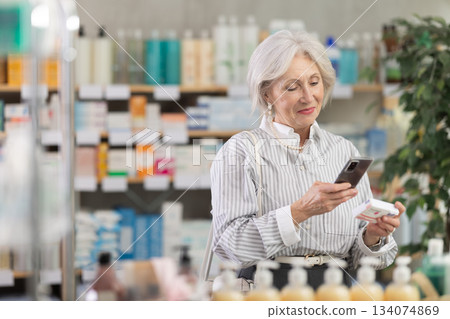 Elderly woman scanning qr code of paracetamol 134074869