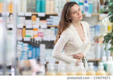 Woman visits pharmacy and suffers from abdominal pain 134074871