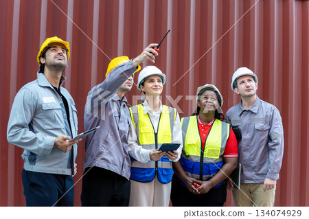 diverse group of construction workers and engineers reviewing on-site operations, focusing on teamwork, safety planning, and industrial coordination while observing structural details together diverse group of construction workers and engineers reviewing on-site operations, focusing on teamwork, safety planning, and industrial coordination while observing structural details together 134074929