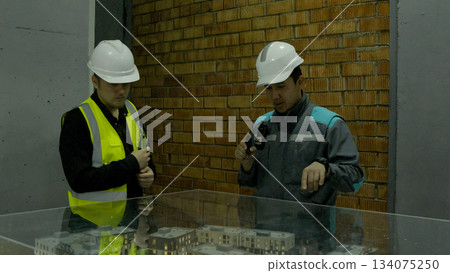 Male engineer or architect wearing a hard hat, inspecting a construction site Male engineer or architect wearing a hard hat, inspecting a construction site 134075250