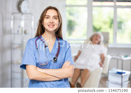 Portrait of young female doctor in scrub. Portrait of young female doctor in scrub. 134075290