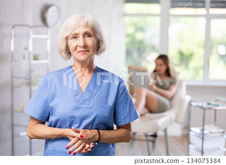 Portrait of elderly doctor in scrub. Portrait of elderly doctor in scrub. 134075384