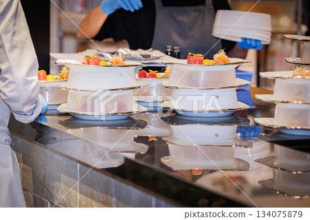 Material image of a chef working in a French kitchen Material image of a chef working in a French kitchen 134075879