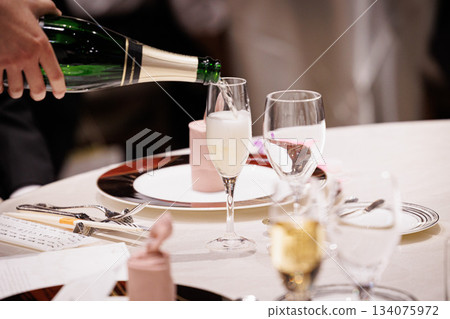 Image of champagne being poured at a formal restaurant 134075972