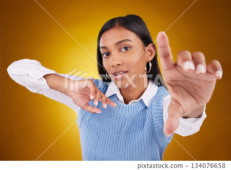 Selfie hand, woman and portrait in studio isolated on a brown background. Face, profile picture and Indian person taking photo for serious memory, social media or photography on a backdrop. 134076658