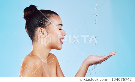 Water drops, skincare and woman with mockup for health, wellness and hygiene isolated on blue studio background. Shower, dermatology and cosmetic beauty glow, model in skin care treatment or routine Water drops, skincare and woman with mockup for health, wellness and hygiene isolated on blue studio background. Shower, dermatology and cosmetic beauty glow, model in skin care treatment or routine 134076742