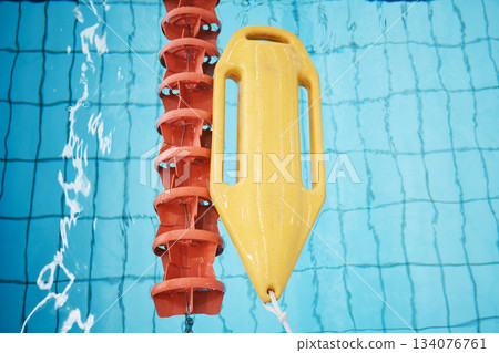 Above, water and a buoy in a pool for safety, life saving and floating help. Board, summer and equipment for protection, security and danger while swimming, rescuing and protecting from drowning Above, water and a buoy in a pool for safety, life saving and floating help. Board, summer and equipment for protection, security and danger while swimming, rescuing and protecting from drowning 134076761