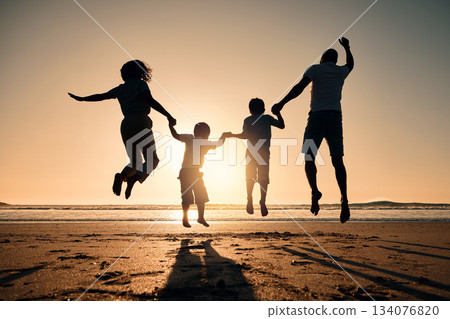 Beach silhouette, sunset and a family jump for freedom, summer energy or travel. Happy, nature and back of a mother, father and children holding hands while jumping at the ocean for celebration 134076820