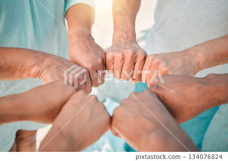 Hands, teamwork and solidarity with people in a huddle together outdoor closeup from above for unity. Collaboration, support and trust with a team or group standing in a circle for motivation 134076824
