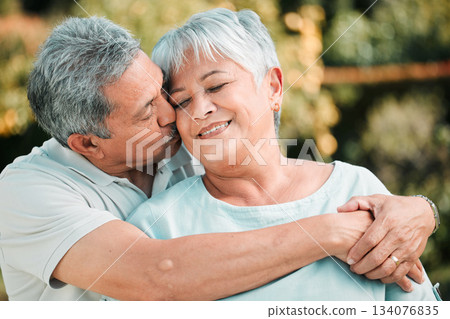 Senior couple, kiss and hug in park, garden and nature for love, care and happiness together. Happy man, woman and retirement of loving partner, relax and support in marriage, quality time or outdoor 134076835