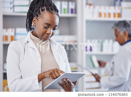 Black woman, doctor and tablet for inventory inspection at pharmacy for healthcare, medication or prescription stock. African female medical expert checking data or research on technology at clinic Black woman, doctor and tablet for inventory inspection at pharmacy for healthcare, medication or prescription stock. African female medical expert checking data or research on technology at clinic 134076865