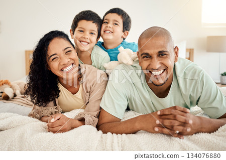 Family, bed and portrait of parents and kids bonding in a bedroom in a house and playing together. Smile, mother and father happy and excited with children in the morning as love and care 134076880