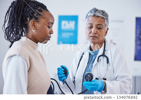 Consultation, doctor and patient with blood pressure test and healthcare advice at clinic. Black woman consulting female medical professional, health care check and expert support or help at hospital Consultation, doctor and patient with blood pressure test and healthcare advice at clinic. Black woman consulting female medical professional, health care check and expert support or help at hospital 134076892