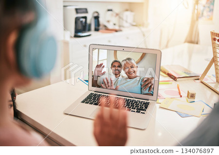 Video call, laptop screen and family wave hello for virtual communication of grandparents, mother and child at home. International, online discussion and happy, senior biracial people talking 134076897