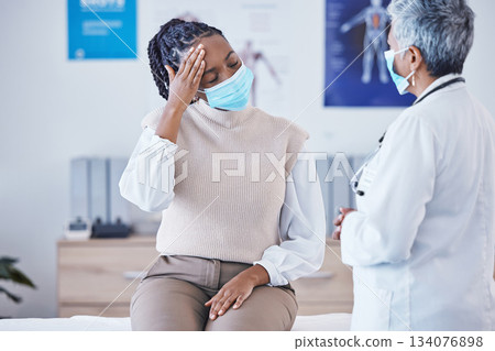 Consultation, doctor and patient with face mask, headache and covid healthcare advice at clinic. Black woman consulting medical professional, health care check and faq, pain info and help at hospital 134076898