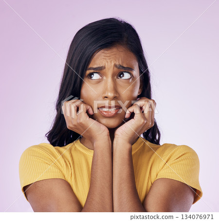 Scared, worry and face of Indian woman on pink background with fear, nervous and confused expression. Stress, anxiety mockup and isolated female with worried, anxious and crisis reaction in studio Scared, worry and face of Indian woman on pink background with fear, nervous and confused expression. Stress, anxiety mockup and isolated female with worried, anxious and crisis reaction in studio 134076971