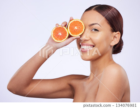 Skincare, orange and woman portrait in studio for vitamin c, treatment and cosmetics on purple background. Face, fruit and girl model relax with diy facial, organic or skin detox with citrus cleaning 134076981