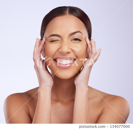 Woman portrait, beauty wink and skincare in a studio with happiness and smile from dermatology. Skin glow, facial and cosmetics of a young female model feeling happy from self care and face wellness Woman portrait, beauty wink and skincare in a studio with happiness and smile from dermatology. Skin glow, facial and cosmetics of a young female model feeling happy from self care and face wellness 134077000