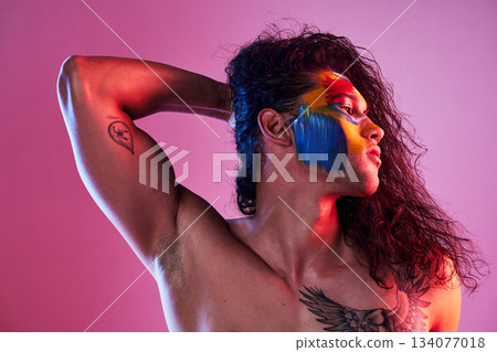Creative, face paint and art with man in studio for beauty, self love and designer. Fantasy, neon and light with male model and colors on pink background for makeup, abstract and cosmetics mockup Creative, face paint and art with man in studio for beauty, self love and designer. Fantasy, neon and light with male model and colors on pink background for makeup, abstract and cosmetics mockup 134077018