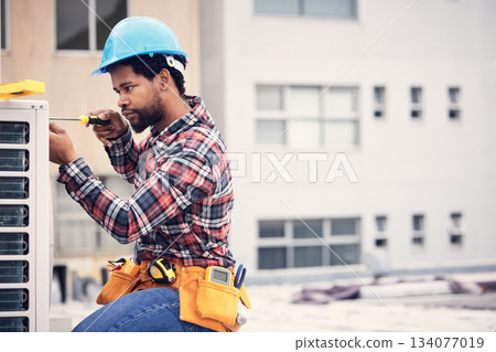 Black man, electrician and maintenance with engineering and ac repair with handyman working with tools on roof. Fix air conditioner, male technician with screwdriver and power generator with service Black man, electrician and maintenance with engineering and ac repair with handyman working with tools on roof. Fix air conditioner, male technician with screwdriver and power generator with service 134077019