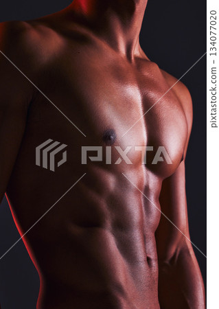 Beauty, closeup and abs of man in studio for fitness, muscle and bodybuilder. Natural, workout and diet with abdomen of male model on black background for six pack, exercise and training 134077020