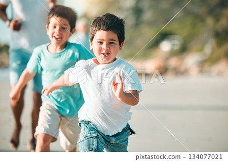 Running, playful and portrait of children at the beach for a holiday, weekend fun and bonding. Happy, freedom and boy kids at the sea in nature to run, play and be free with family on vacation Running, playful and portrait of children at the beach for a holiday, weekend fun and bonding. Happy, freedom and boy kids at the sea in nature to run, play and be free with family on vacation 134077021