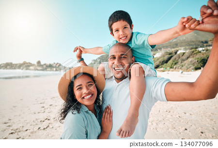 Family, happy and portrait at beach for summer with child, mother and father for fun. Man, woman and boy kid smile for happiness, play and freedom on a holiday with love, adventure and travel outdoor 134077096