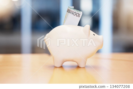 Saving, money and piggybank on a table for finance, budget and investment. Security, dollar and a tool for savings, cash safety and financial growth at a company for banking and pension wealth Saving, money and piggybank on a table for finance, budget and investment. Security, dollar and a tool for savings, cash safety and financial growth at a company for banking and pension wealth 134077208