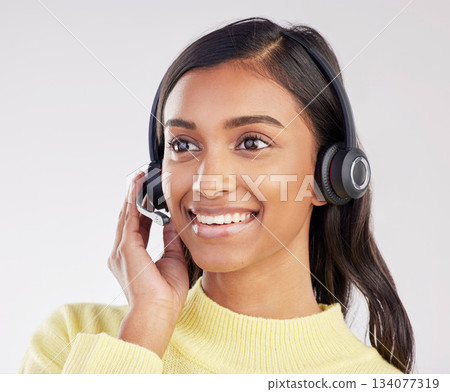 Woman has smile on face, callcenter and headset with mic, CRM and contact us with consultant on studio background. Happy, Indian female with customer service agent and help desk with tech support Woman has smile on face, callcenter and headset with mic, CRM and contact us with consultant on studio background. Happy, Indian female with customer service agent and help desk with tech support 134077319