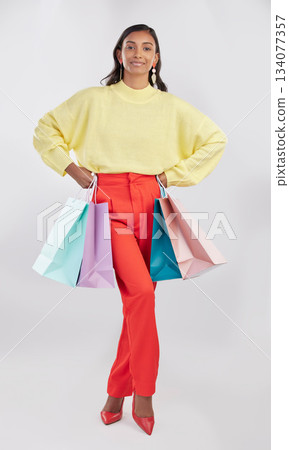 Portrait, fashion and woman with bags, shopping and glamour against a white studio background. Face, female shopper or model with products, elegant person and holding gifts with smile, brand and sale Portrait, fashion and woman with bags, shopping and glamour against a white studio background. Face, female shopper or model with products, elegant person and holding gifts with smile, brand and sale 134077357