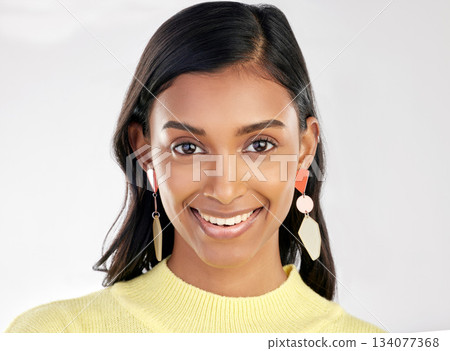 Portrait, fashion and beauty with a woman on a white background in studio wearing earrings or accessories. Face, smile and happy with an attractive young indian female closeup for contemporary style Portrait, fashion and beauty with a woman on a white background in studio wearing earrings or accessories. Face, smile and happy with an attractive young indian female closeup for contemporary style 134077368