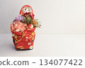 A Japanese-style New Year's arrangement of Daruma and carnations in gentle light 134077422