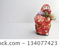 Auspicious Japanese New Year decorations of Daruma and flowers that stand out against a white background 134077423