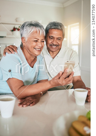 Phone, video call and elderly couple in a kitchen happy, smile and embrace in their home. Smartphone, love and old people pose for selfie, photo or profile picture while enjoying retirement together Phone, video call and elderly couple in a kitchen happy, smile and embrace in their home. Smartphone, love and old people pose for selfie, photo or profile picture while enjoying retirement together 134077590