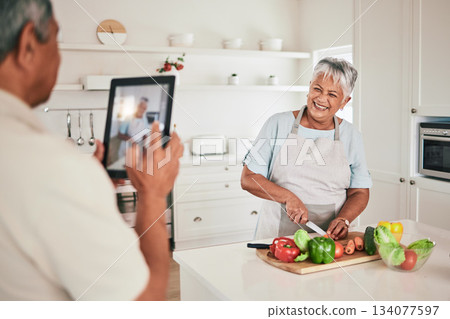 Kitchen cooking, elderly couple or tablet photo of senior woman, wife or person with online memory picture. Nutritionist food, love or laughing people bonding, happy and prepare vegetable ingredients Kitchen cooking, elderly couple or tablet photo of senior woman, wife or person with online memory picture. Nutritionist food, love or laughing people bonding, happy and prepare vegetable ingredients 134077597