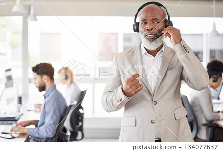 Black man, call center and consulting manager on headphones for customer service or agent support at office. African American, senior or businessman consultant talking on headset for online advice 134077637