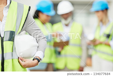 Industry, hardhat and closeup of a woman construction worker with safety equipment or gear. Builder, professional and zoom of a female industrial foreman worker with her building team on a site. Industry, hardhat and closeup of a woman construction worker with safety equipment or gear. Builder, professional and zoom of a female industrial foreman worker with her building team on a site. 134077684
