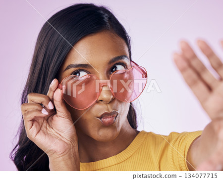 Selfie, heart and sunglasses by indian woman in studio emoji, cool and fun on purple background. Glasses, trendy and female gen z fashion influencer posing for profile picture, photo or blog post Selfie, heart and sunglasses by indian woman in studio emoji, cool and fun on purple background. Glasses, trendy and female gen z fashion influencer posing for profile picture, photo or blog post 134077715