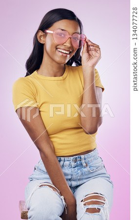 Sunglasses, fashion and portrait of happy Indian woman on pink background with smile, confidence and beauty. Happiness, summer aesthetic and girl in studio with cosmetics, accessories and style 134077728