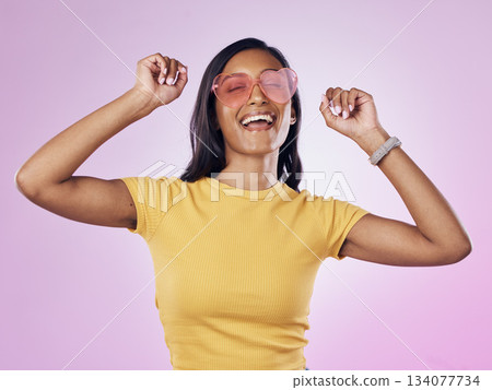 Dance, sunglasses and happy woman excited, cool and confident isolated in a pink studio background with joy. Singing, music and young gen z female dancing celebration of a party energy with glasses Dance, sunglasses and happy woman excited, cool and confident isolated in a pink studio background with joy. Singing, music and young gen z female dancing celebration of a party energy with glasses 134077734