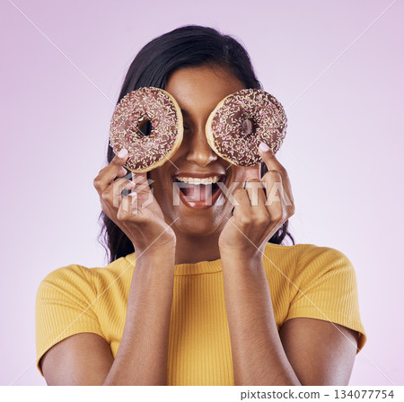 Donut, dessert and cover with woman in studio for diet, snack and happiness. Sugar, food and smile with female hiding and isolated on pink background for nutrition, playful and craving mockup 134077754