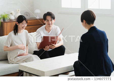 A couple listening to an explanation of insurance Lifestyle image 134077771