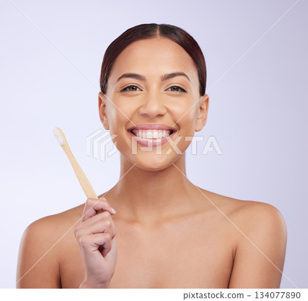 Happy, dental health and portrait of a woman with a toothbrush isolated on a white background in a studio. Smile, grooming and a girl brushing teeth and showing results from a whitening treatment 134077890