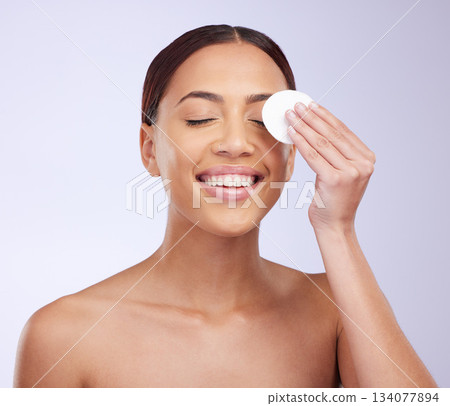 Beauty, skincare and cotton swab with a woman in studio on a gray background for natural treatment. Facial, wellness and anti aging with an attractive young female exfoliating her face or skin Beauty, skincare and cotton swab with a woman in studio on a gray background for natural treatment. Facial, wellness and anti aging with an attractive young female exfoliating her face or skin 134077894