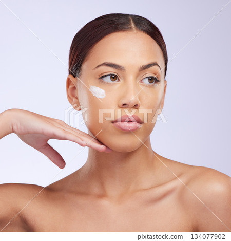 Woman, skincare cream and thinking in studio for self care, aesthetic or beauty with product application on face. Girl, model and facial skin wellness with cosmetic, health or dermatology by backdrop Woman, skincare cream and thinking in studio for self care, aesthetic or beauty with product application on face. Girl, model and facial skin wellness with cosmetic, health or dermatology by backdrop 134077902