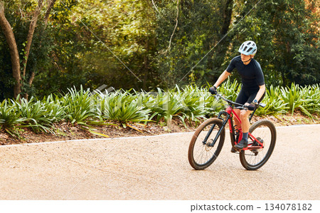 Sports, nature and woman cycling on a bicycle while training for a race, marathon or competition. Fitness, workout and female athlete cyclist doing cardio exercise on a bike on outdoor trail in park. Sports, nature and woman cycling on a bicycle while training for a race, marathon or competition. Fitness, workout and female athlete cyclist doing cardio exercise on a bike on outdoor trail in park. 134078182