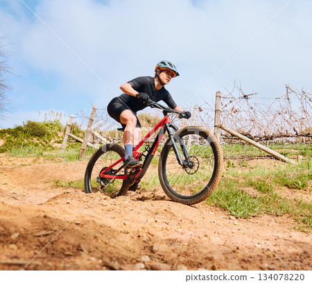 Bicycle fitness, countryside road and woman on a bike with speed for sports race on cycling path. Adventure, biker exercise and fast athlete doing training in nature on a trail for cardio and workout Bicycle fitness, countryside road and woman on a bike with speed for sports race on cycling path. Adventure, biker exercise and fast athlete doing training in nature on a trail for cardio and workout 134078220