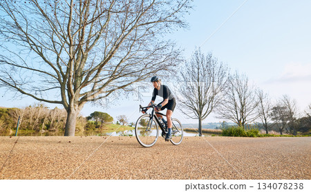 Sports, bicycle and woman cycling in a forest for fitness, exercise and morning cardio in nature. Training, bike and female enjoying workout in a park, freedom and energy, performance and endurance Sports, bicycle and woman cycling in a forest for fitness, exercise and morning cardio in nature. Training, bike and female enjoying workout in a park, freedom and energy, performance and endurance 134078238